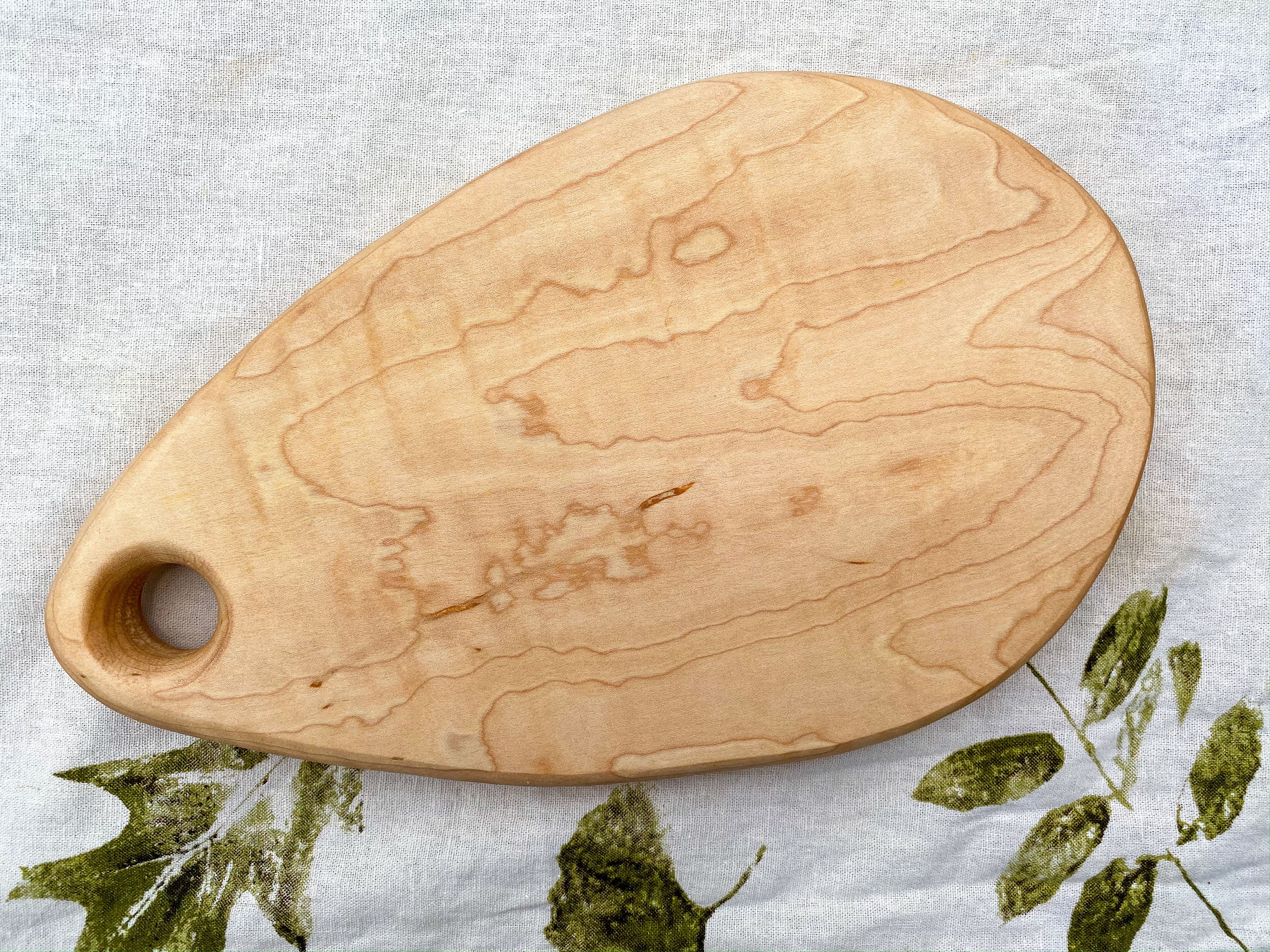 handmade 11" x 7" curely maple wood tear drop cheese board.