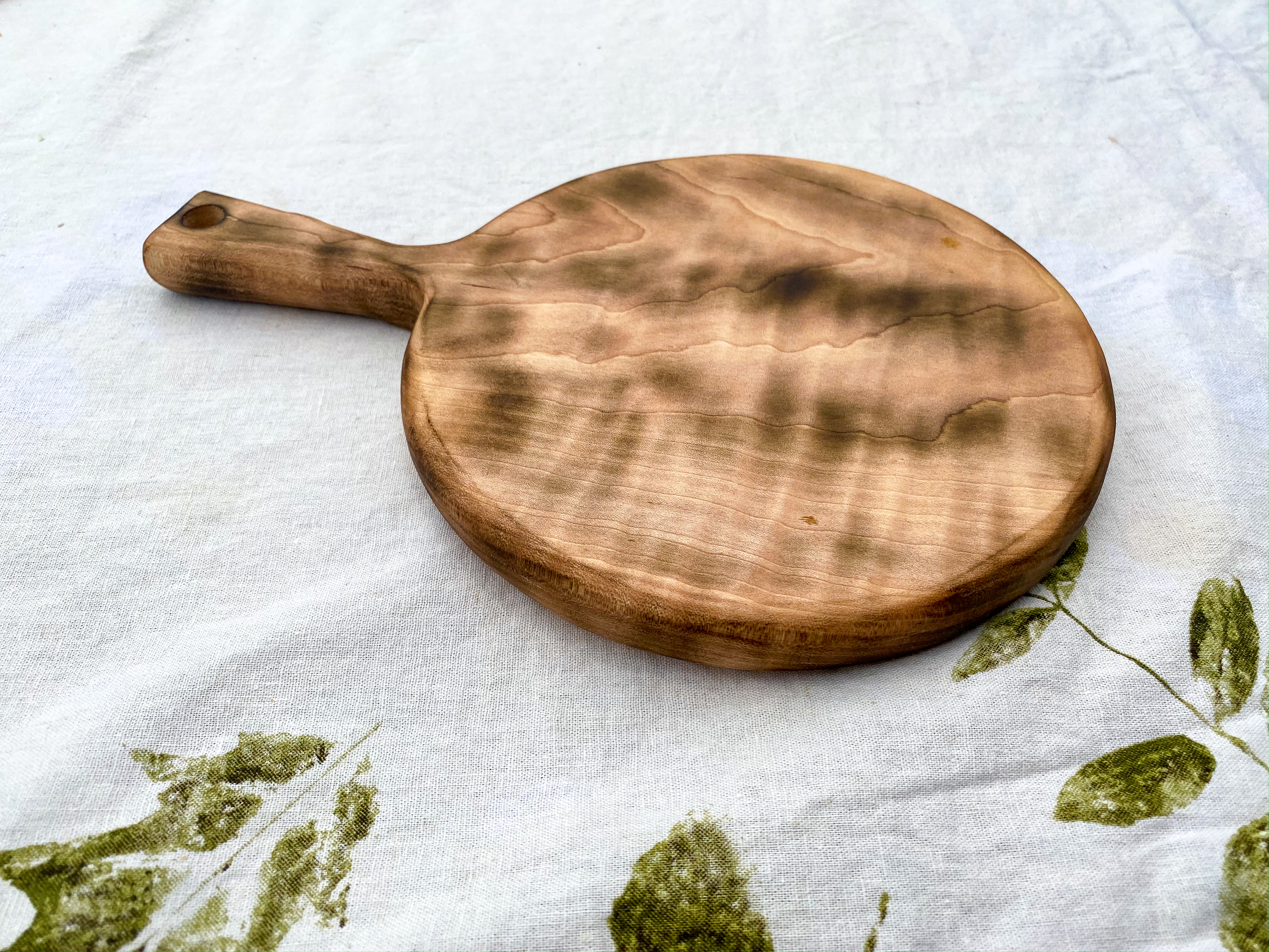 Handmade 8" x 12" distressed curley maple wood tear round cheese board.